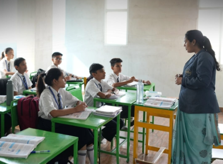 Students learning mathematics in classroom at Colours School